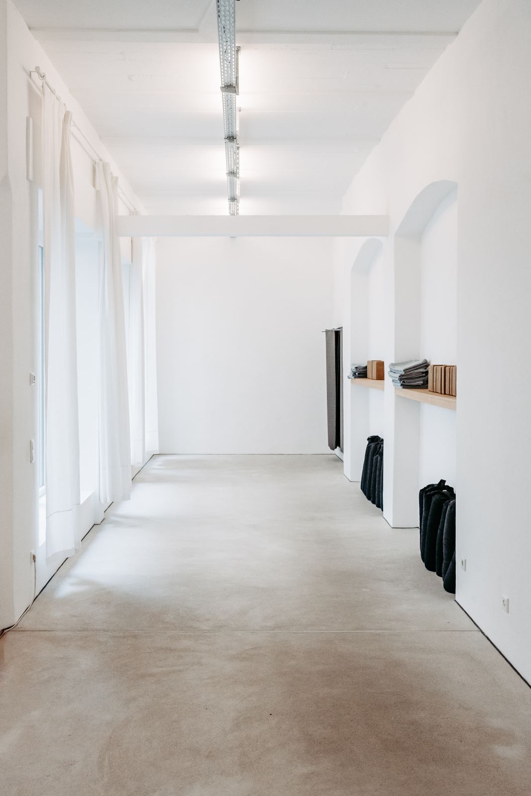 Morning light along a white studio hallway